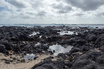 water pooling on rocky beach