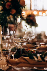 Fototapeta na wymiar Wedding table with shining glasses and beautiful decoration