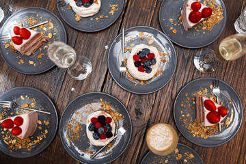 Top view, sweet cakes with summer berries on a wooden table. Party, sweet table. Summer offer desserts in the restaurant.