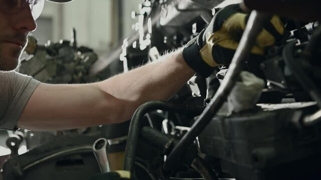 Automotive Mechanic Inspecting And Trying To Solve Problem With Vehicle Engine Failure. 