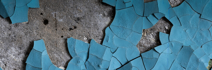 Peeling paint on the wall. Panorama of a concrete wall with old cracked flaking paint. Weathered...