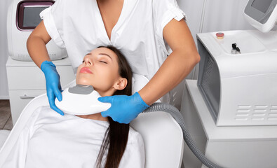 Elos epilation hair removal procedure on the face of a woman. Beautician doing laser rejuvenation...
