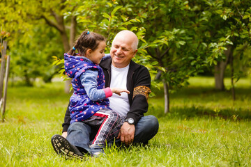 Fototapeta premium Beautiful granddaughter visiting her elderly kind grandfather.