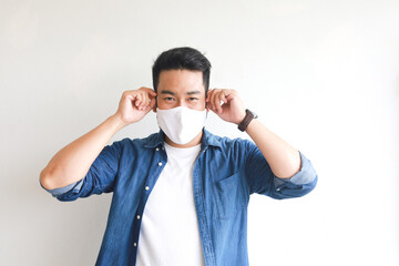 Asian man with face mask on white 
