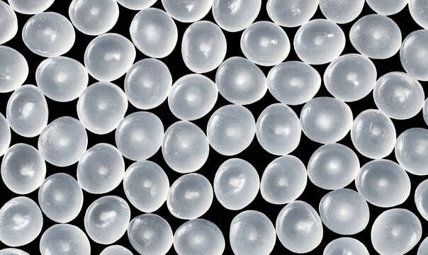 Close up picture of polypropylene granules on a black background.