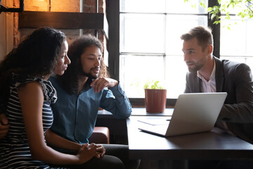 Real estate agent company representative tell to mixed-race couple about new great offer showing...
