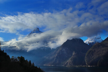 clouds and mountains with a lake in foreground near Brunnen