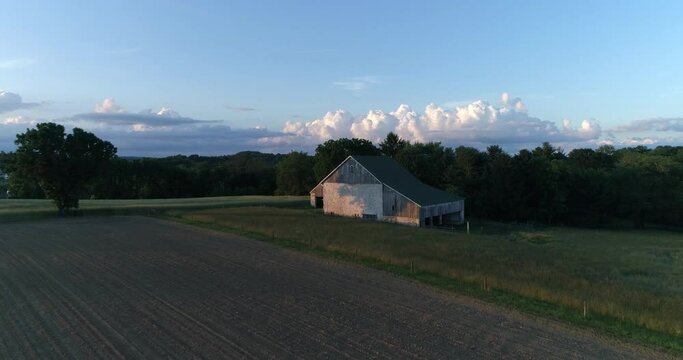 A barn surrounded by a wheat field in the rural Pennsylvania countryside during 