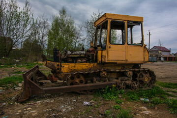 Fototapeta na wymiar Broken tractor on tracks in the field