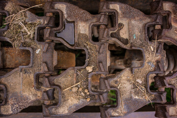 Rusty caterpillar of an old tractor.
