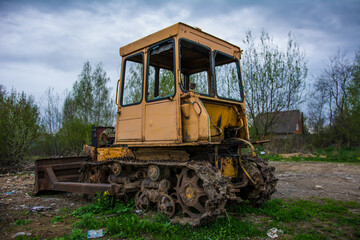Broken tractor on tracks in the field