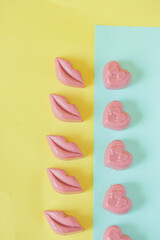 Chocolate candies on a turquoise and yellow background. Place for photo. Advertising photo.
