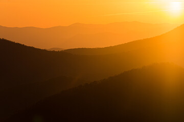 Dramatic orange color defines the ridges of the Blue Ridge mountains.