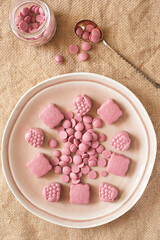 Obraz na płótnie Canvas On a burlap of pink chocolate candy. 