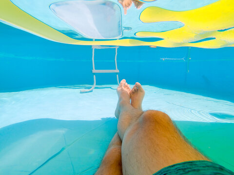 Pov Of A Man Relaxing In The Pool Under A Floating Air Mattress