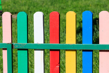 Close-up of the multicolored painted wooden fence