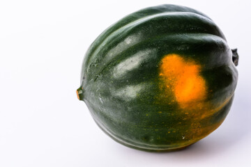 Green and orange acorn pumpkin on a white background.