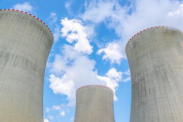 Cooling towers of nuclear power plant. On sunny day with blue sky and white clouds