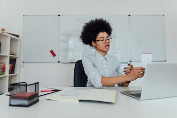 Online English School. Young afro american female teacher explaining the rules of English grammar...
