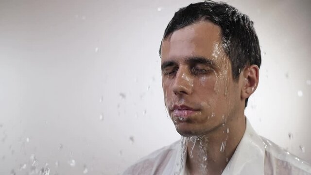 Water splash on face of a man