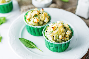 Spinach Feta cheese breakfast muffins with fresh spinach leaves