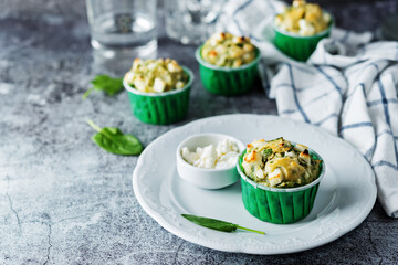 Spinach Feta cheese breakfast muffins with fresh spinach leaves