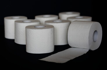 toilet paper rolls on black background