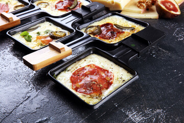 Delicious traditional Swiss melted raclette cheese on diced boiled or baked potato.