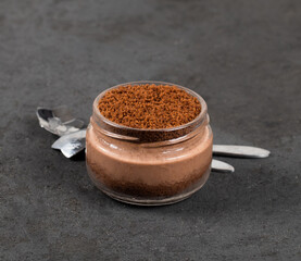 Dessert chocolate cream cottage cheese with cookies, cheesecake without baking in a jar on a dark gray background