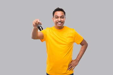 Indian Man Smilling Showing Car Keys Isolated. Driver