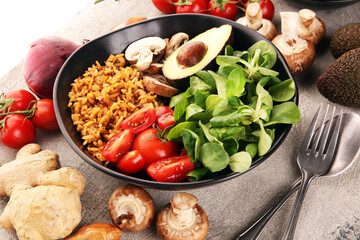 Healthy vegan salad bowl with quinoa, tomatoes, avocado and mixed greens, lettuce. Food and health bowl