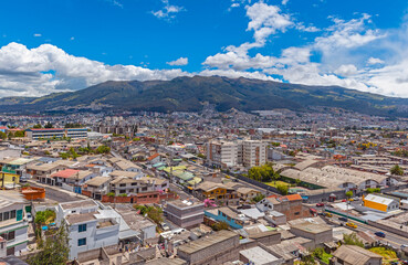 Aerial urban skyline of Quito city with the Pichincha volcano, Ecuador.