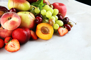 Fresh summer fruits with apple, grapes, berries, plums and healthy apricot.