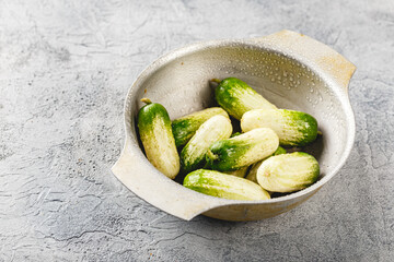 Baby cucumber on gray background