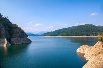 A beautiful landscape with the Vidra lake. Transfagarasan Road. The calm water of the storage lake Vidra.