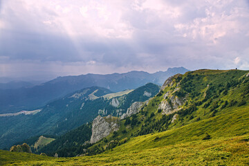 A beautiful landscape on the red mountain with fir trees and forest. A famous sky and a light effect.