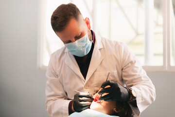 dentist attending girl, care with instruments in clinic