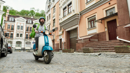 Wait a minute for delicious. Delivery man in helmet with thermo bag or backpack riding a motor...