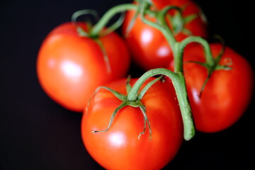 red tomatoes on a black close up