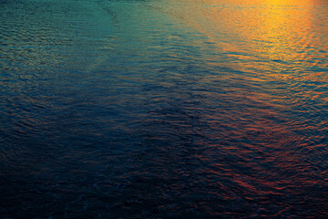 Sea water in the Sunset light . Colored reflection in the sea water