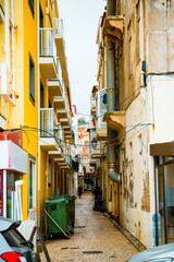 Fototapeta na wymiar NAZARE, PORTUGAL, MAY 8, 2019: View of a narrow street in Nazare, Portugal