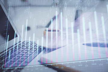 Double exposure of financial chart drawing and desktop with coffee and items on table background. Concept of forex market trading