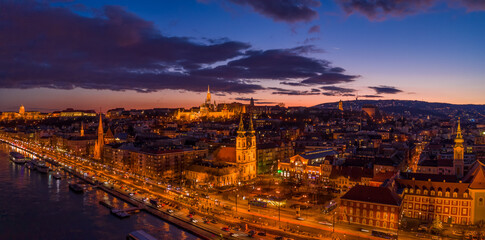 Panoramic aerial drone shot of Matthias Churh, St. Anne Church and market hall by Danube in...
