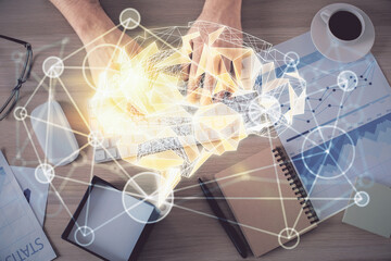 Double exposure of man's hands typing over computer keyboard and brain hologram drawing. Top view. Ai and data technology concept.