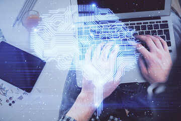 Double exposure of man's hands typing over computer keyboard and brain hologram drawing. Top view. Ai and data technology concept.