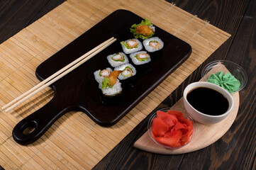 Fototapeta na wymiar Sushi roll set with salad and fried shrimp