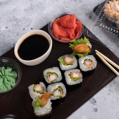Sushi roll set with fried shrimp and salad