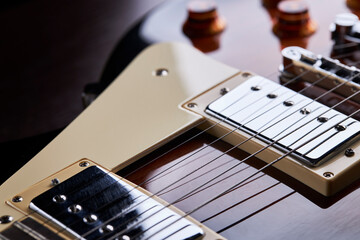 Fototapeta premium high contrast close up view for electric guitar. side view. music still life concept.