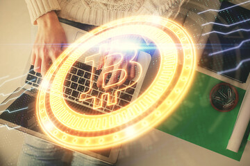 Double exposure of woman hands working on computer and blockchain theme hologram drawing. Top View....