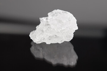 rock salt crystal over dark background.  outer space.